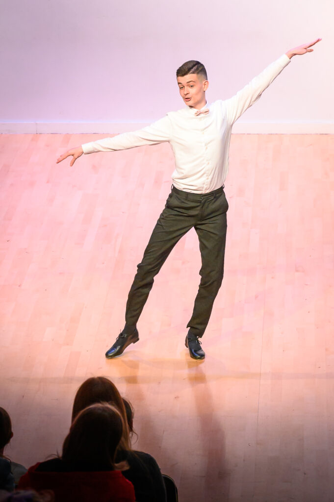 A student dancing on stage