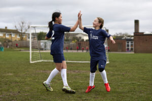 Two children high-fiving each other