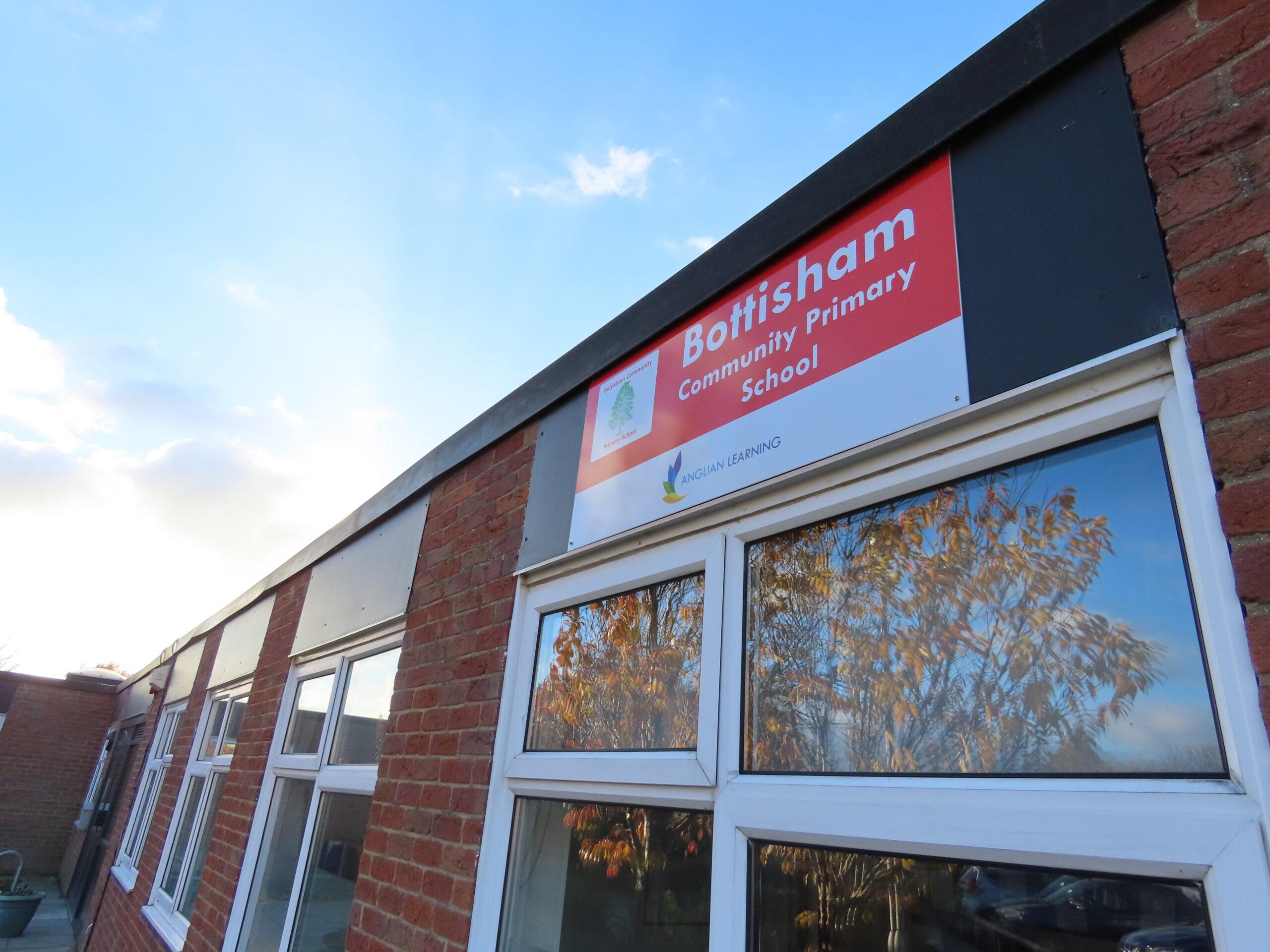 A sign that says Bottisham Community Primary School and Anglian Learning