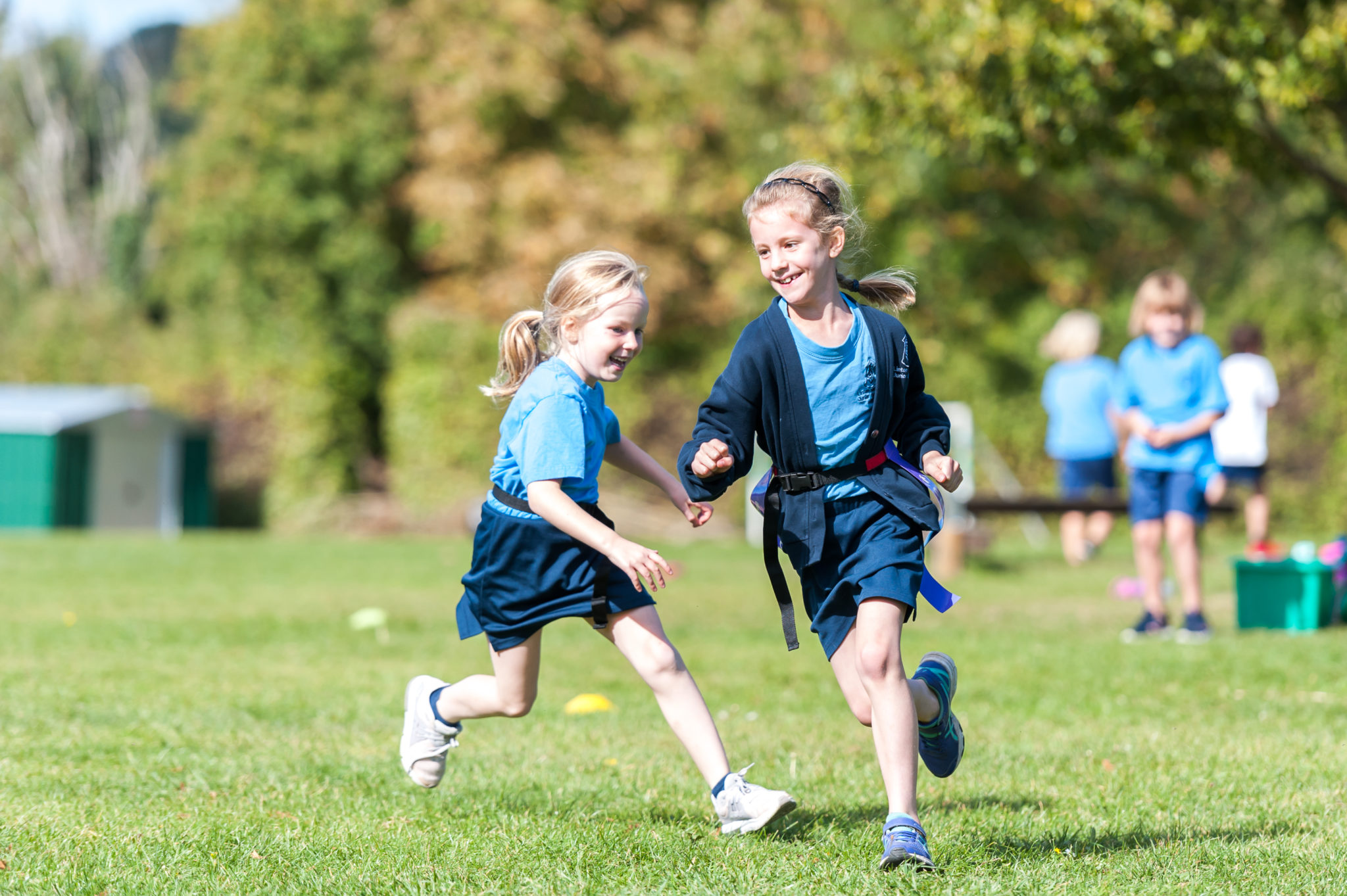 Two children running on a field