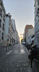 A sunset over a street with buildings