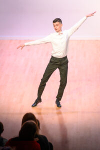 A student dancing on stage