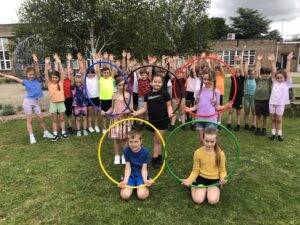 A group of children holding hula hoops