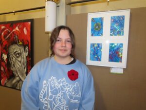 Pupil standing beside artwork.